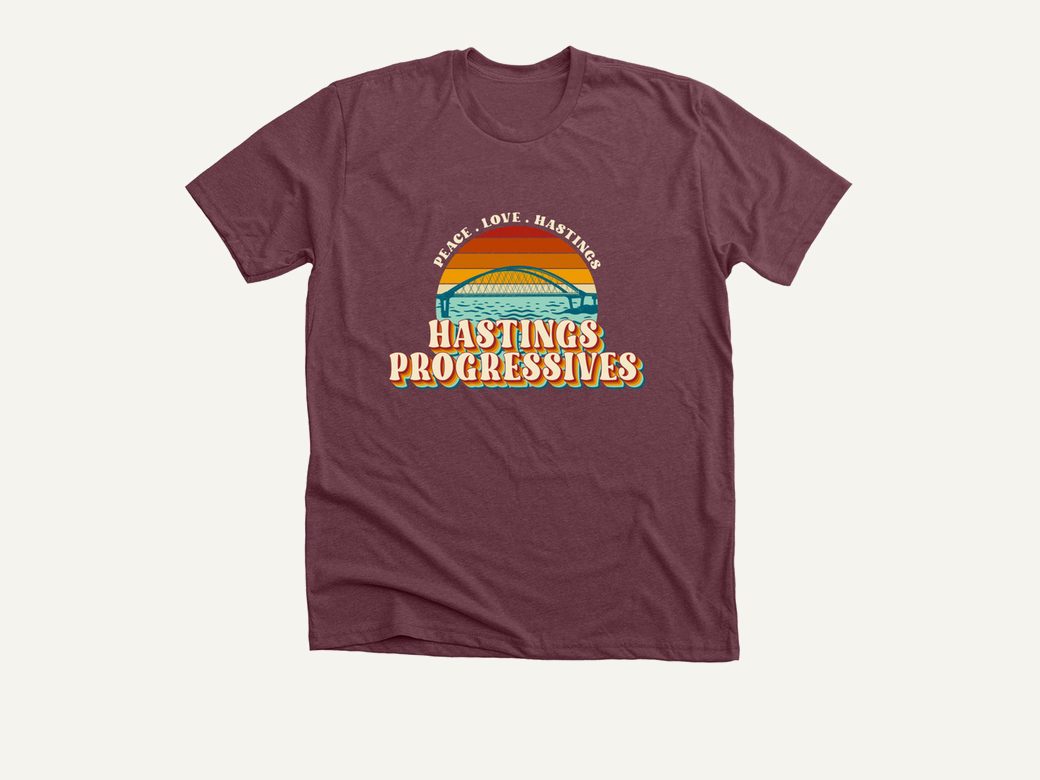 Hastings Progressives sunset bridge logo on a maroon tee.